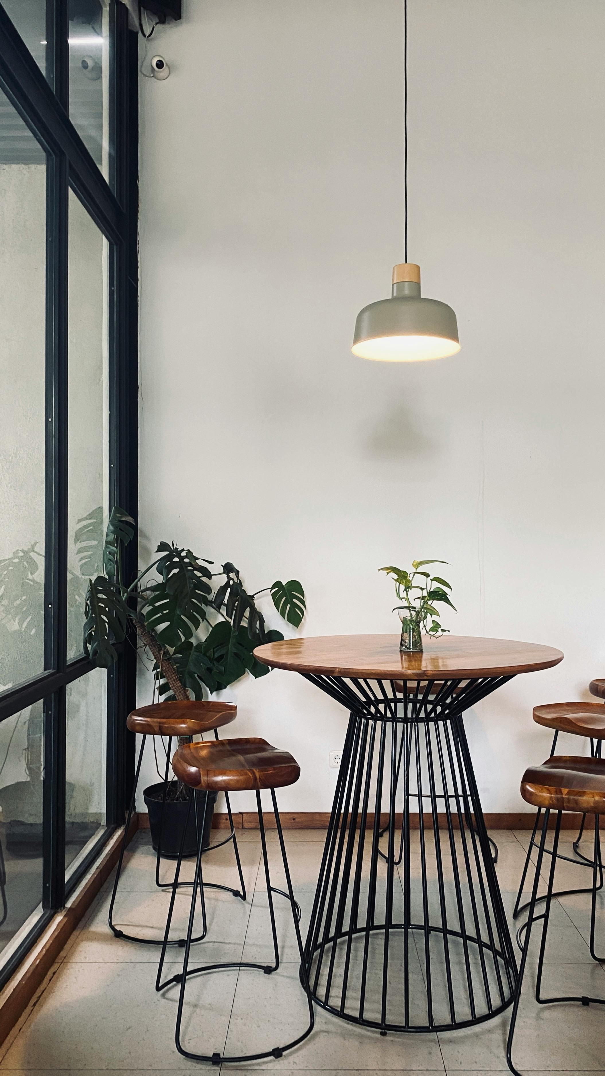 Stylish minimalist cafe interior with wooden furnishings in Malang, Indonesia.